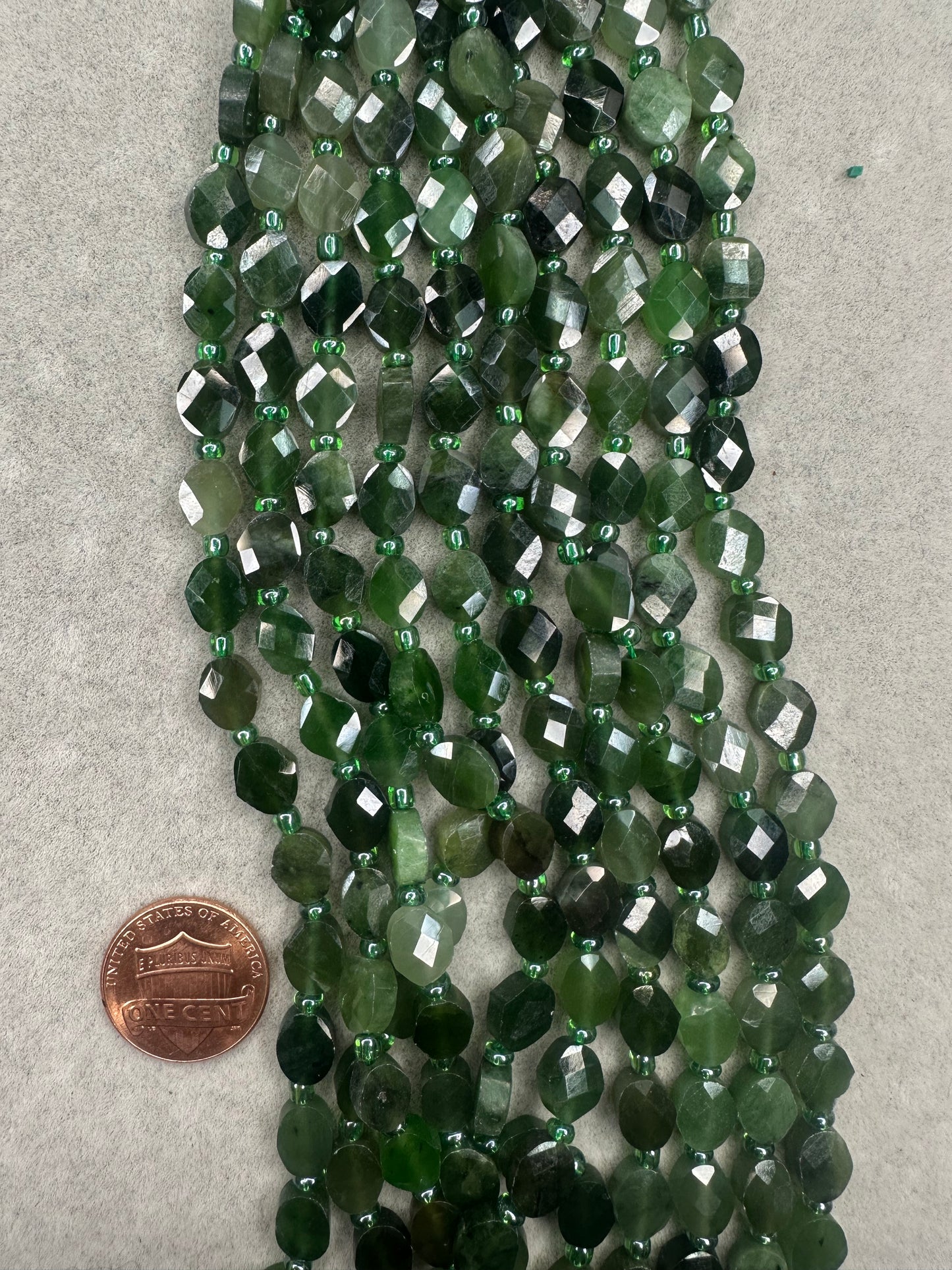 canadian jade oval shape faceted 6mmx9mm 16"strand