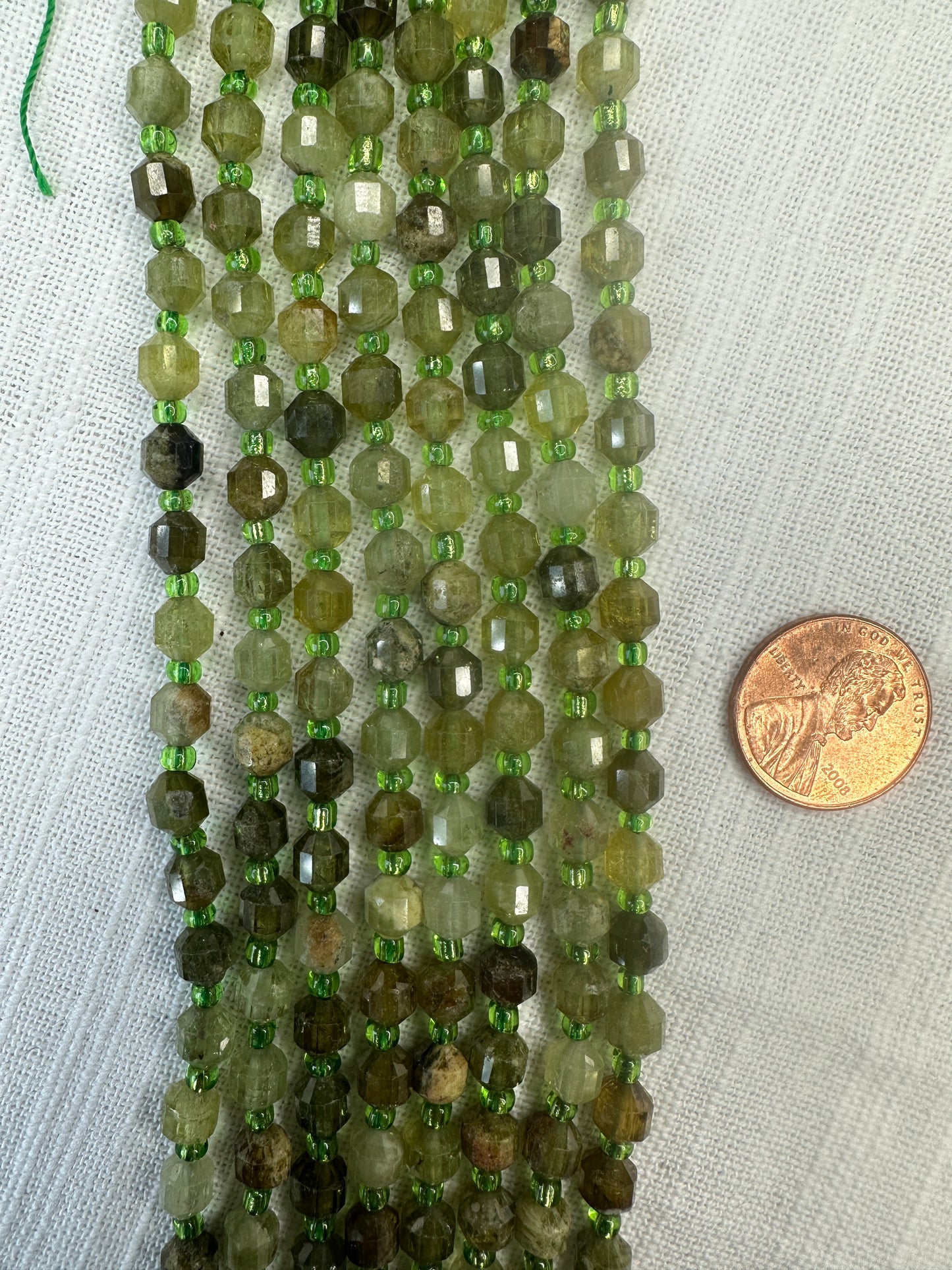 grossular green garnet 6mm art deco lantern shape 15.5"strand