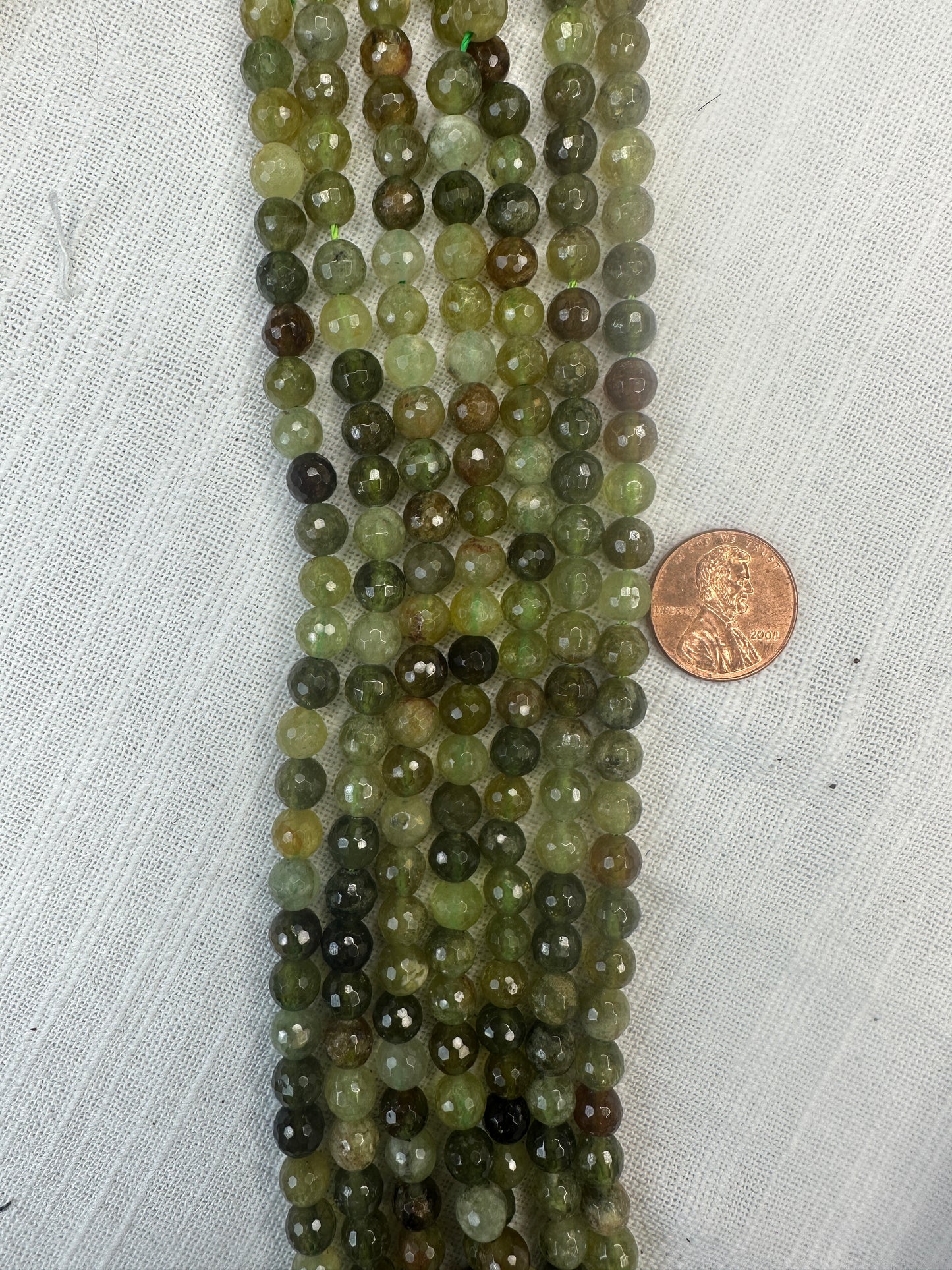 grossular green garnet 6.5mm round faceted shape 15.5"strand